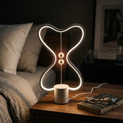 Lumiqia floating balance LED night lamp glowing on nightstand