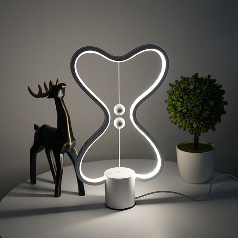 Lumiqia floating balance LED night lamp glowing on nightstand