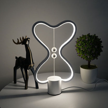 Lumiqia floating balance LED night lamp glowing on nightstand