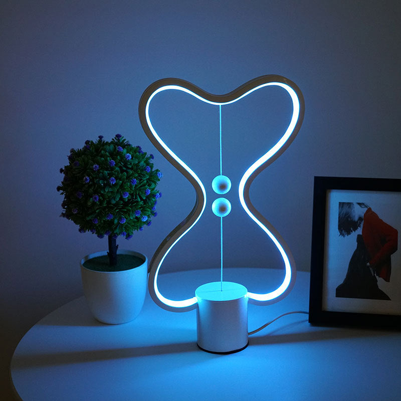 Lumiqia floating balance LED night lamp glowing on nightstand