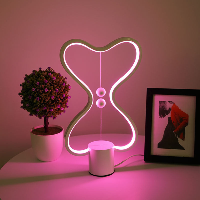 Lumiqia floating balance LED night lamp glowing on nightstand