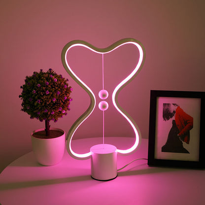 Lumiqia floating balance LED night lamp glowing on nightstand