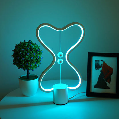 Lumiqia floating balance LED night lamp glowing on nightstand