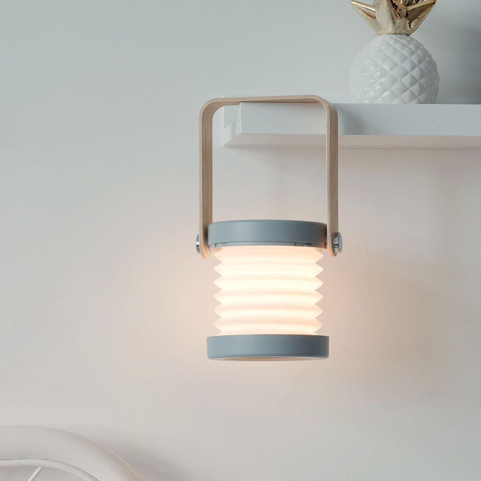 Lumiqia foldable touch dimmable lantern lamp glowing on bedside table